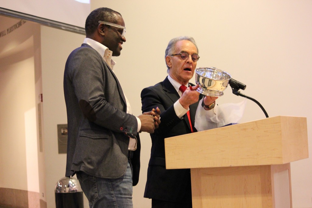 Alain Mabanckou receiving the 2016 Puterbaugh Pewter Bowl from World Literature Today executive director R.C. Davis