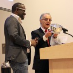 Alain Mabanckou receiving the 2016 Puterbaugh Pewter Bowl from World Literature Today executive director R.C. Davis