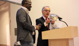 Alain Mabanckou receiving the 2016 Puterbaugh Pewter Bowl from World Literature Today executive director R.C. Davis